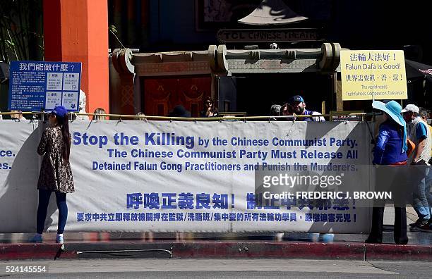 Falun gong practitioners protest in front of the Chinese-owned TCL Theater in Hollywood, California on the 17th anniversary of their protest in...