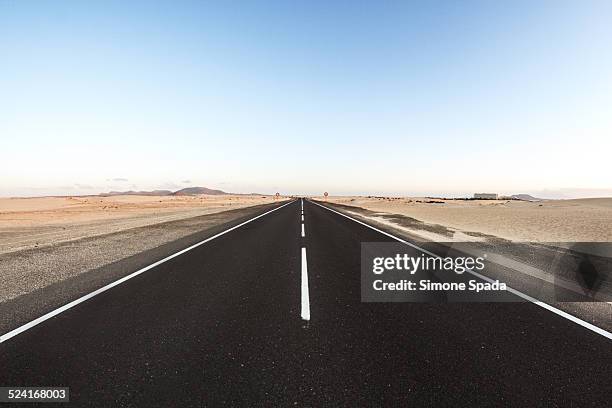 road across parque natural de corralejo - corralejo stock pictures, royalty-free photos & images