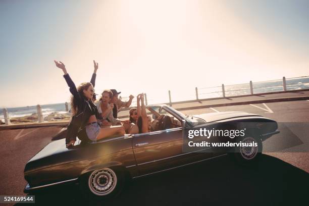 multi-ethnic teenager friends traveling to the sea on a converti - car young and old person stock pictures, royalty-free photos & images