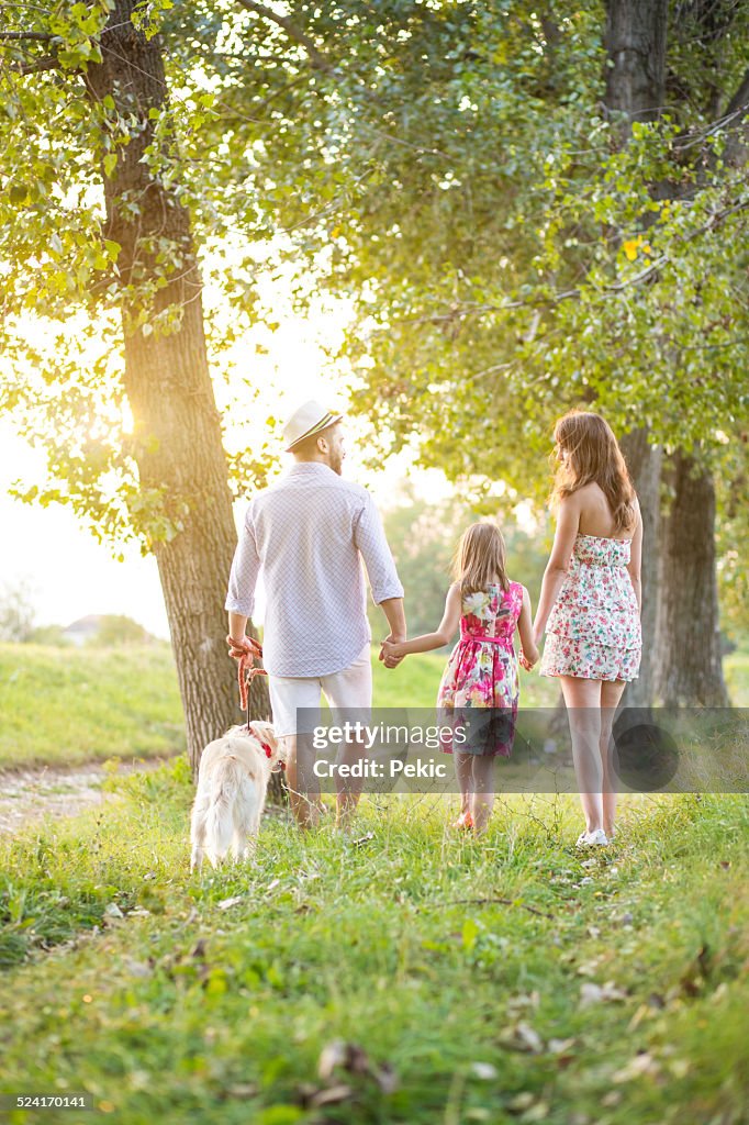 Happy young family on a summer day with their dog