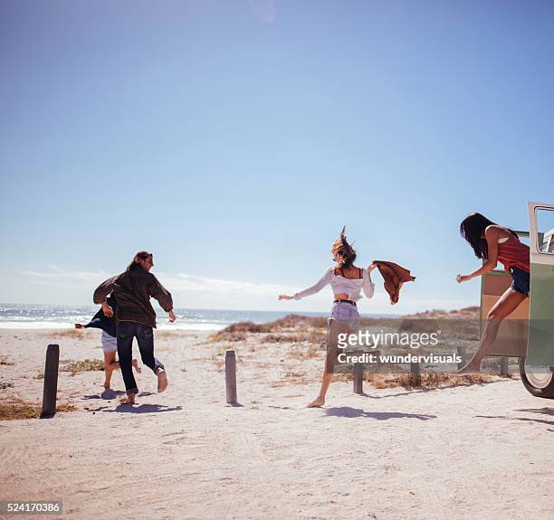 hipster friends jumping out of road trip van at beach - car young and old person stock pictures, royalty-free photos & images