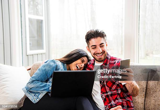 relaxen und spaß - indian couple at home stock-fotos und bilder