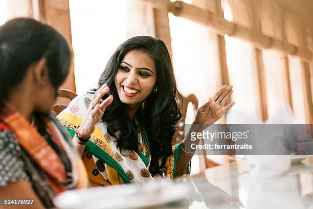 young indian women dining together - indian ethnicity travel stock pictures, royalty-free photos & images