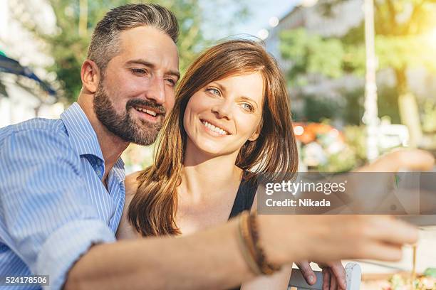 young happy couple taking a selfie with cell phone outdoors - portrait hippster stock pictures, royalty-free photos & images