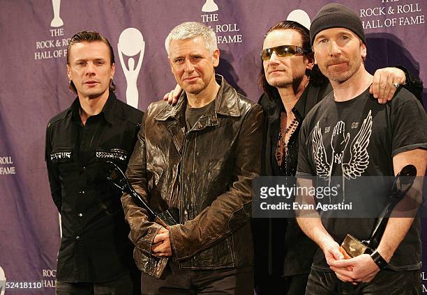 Inductees Larry Mullen Jr., Adam Clayton, Bono and The Edge of the rock group U2 pose backstage at the 20th Annual Rock And Roll Hall Of Fame...