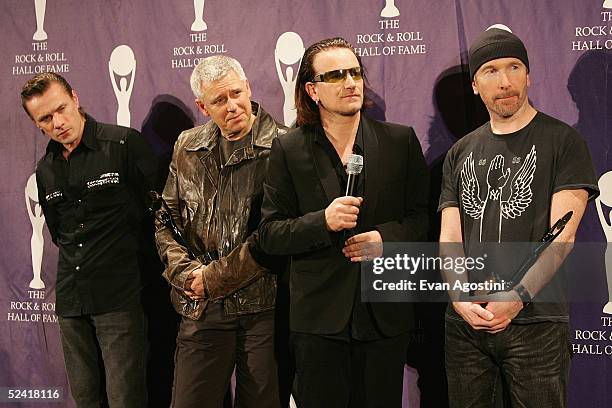 Inductees Larry Mullen Jr., Adam Clayton, Bono and The Edge of the rock group U2 pose backstage at the 20th Annual Rock And Roll Hall Of Fame...