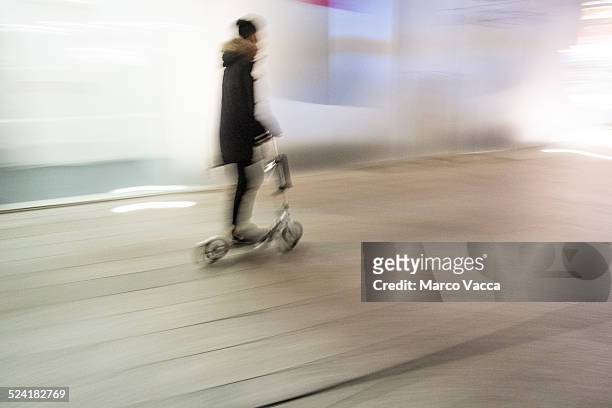 riding on a pushscooter - man on scooter stock pictures, royalty-free photos & images