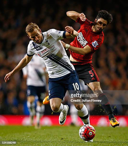 Harry Kane of Tottenham Hotspur is challenged by Claudio Yacob of West Bromwich Albion during the Barclays Premier League match between Tottenham...