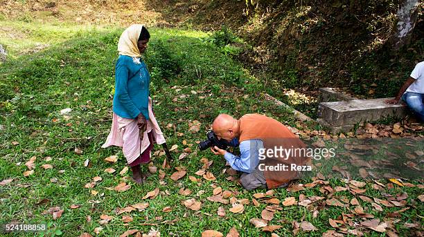 January 2013, Coffee plantation Pombolakku, Kodagu District, Virajpet, Karnataka State, India. The photographer Reza on his knees taking the feet of...