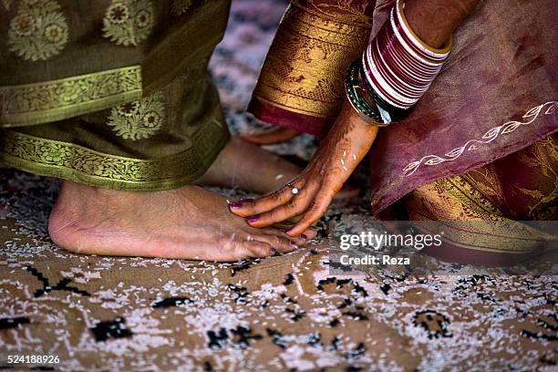 January 2013, Captal, Madikeri, Kodagu District, Karnataka State, India. The bride touches the feet of an honored guest as a sign of respect during a...