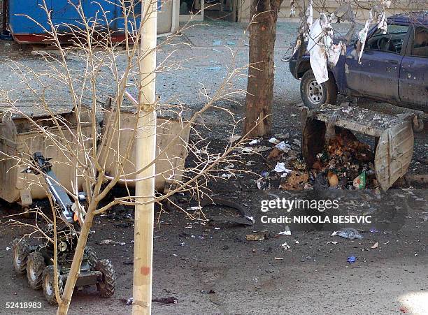 Pictures a shows a damaged car and a destroyed garbage container where an explosive device was apparently placed in Pristina 15 March 2005. Kosovo...