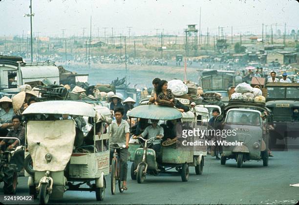 Street congested with traffic as refugees flee in automobiles to Saigon near the end of the Vietnam War, South Vietnam.
