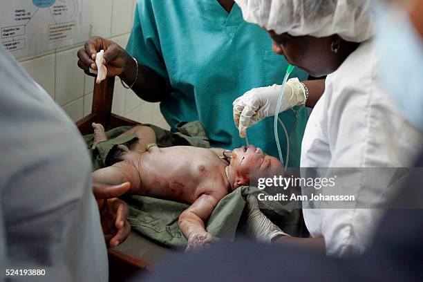 Medical staff clears a newborn baby's oxygen passage way at the Princess Children Medical Hospital in Freetown, Sierra Leone, November 17, 2008.