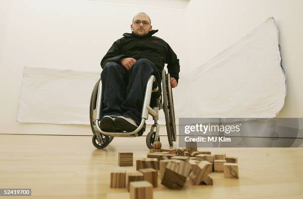 Artist Ryan Gander poses with his artwork entries at the exhibition of work by artists shortlisted for contemporary art award, the Becks Futures...