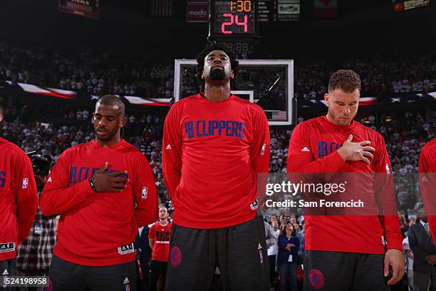 Chris Paul, DeAndre Jordan and Blake Griffin of the Los Angeles Clippers stands for the national anthem prior to the game against the Portland Trail...
