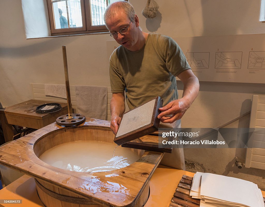 Pulp Vat A worker makes a sheet of paper at a paper pulp vat in the Basel ...