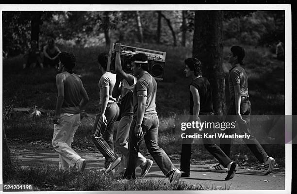 Group of young men carries a portable stereo through Central Park in Manhattan.