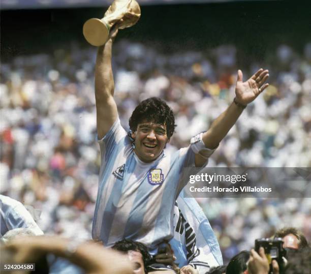 Argentinian soccer ace Diego Maradona lifts the trophy after Argentina was crowned world champion of the 1986 World Cup at the Azteca Stadium in...