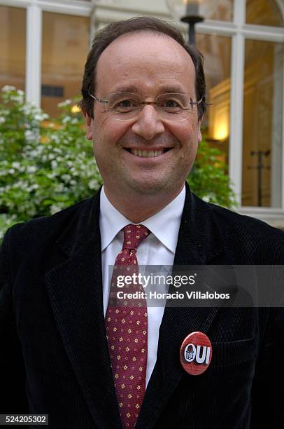 Francois Hollande, First Secretary of the French Socialist Party, wears a "Oui" badge outside French Socialist Party headquarters after a meeting to...