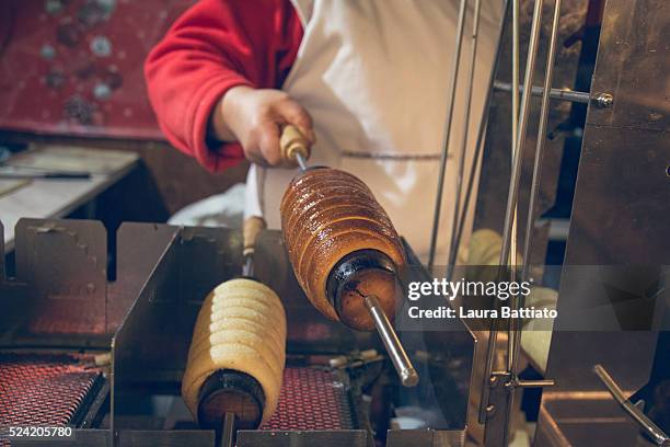 making trdelnik in a trdlo, traditional czech and slovak pastry - trdelník stock pictures, royalty-free photos & images