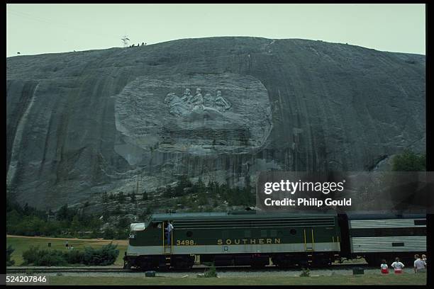 Train passes the bas relief sculpture on Stone Mountain. The sculpture depicts the images of Confederate President Jefferson Davis, Generals Robert...