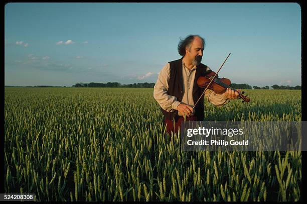 Michael Doucet, a fiddler for the Cajun band Beausoleil, plays in a field in Lafayette, Louisiana.