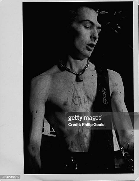Sid Vicious plays bass during a Sex Pistols concert in Dallas, Texas. His nose is bloodied after being punched by a fan.