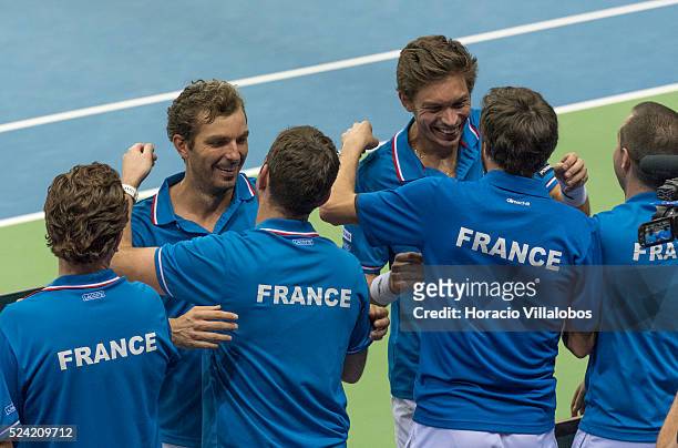 Julien Benneteau and Nicolas Mahut embrace team members at the end of the doubles played against Benjamin Becker and Andre Begemann of Germany, on...