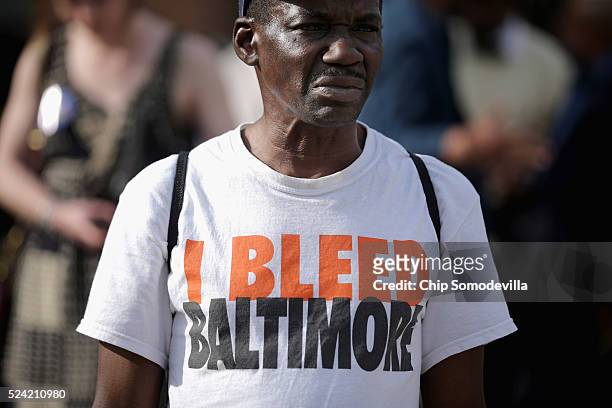 Desmond Williams joins about 100 people for a rally to mark the anniversary of the death of city resident Freddie Gray at the War Memorial Plaza...