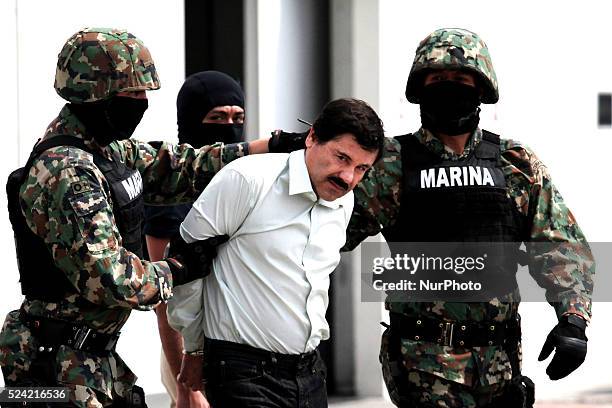 Mexican Navy soldiers escort Joaquin Guzman Loera , alias "El Chapo Guzman", leader of the Sinaloa Cartel, during his show up in front of the press,...