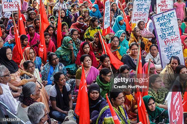 Dhaka, Bangladesh, 07th March 2014: Women take part in the Bangladeshi Communist Party rally for International Women's Day, holding flags and signs...