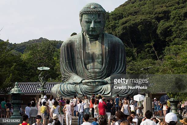 Tourists visiting the Great Buddha of Kamakura Statue on July 21 2014 in Kamakura south of Tokyo. The Great Buddha of Kamakura statue builded in 1252...