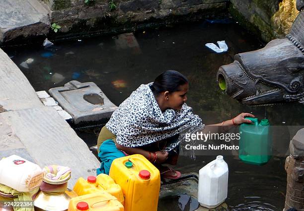 Women tries to fill water in the water tank from the traditional stone tap in Patan near Kathmandu, Nepal, March 22, 2015. World Water Day is...