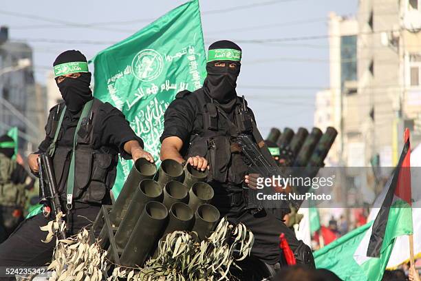 Palestinian militants of the Ezzedine al-Qassam brigade, the armed wing Hamas, parade with Rocket launcher in Gaza city, on November 14 during an...