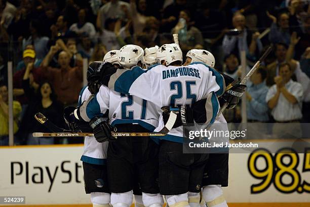 Center Vincent Damphousse of the San Jose Sharks celebrates with teammates during game three of the Stanley Cup playoffs western conference...