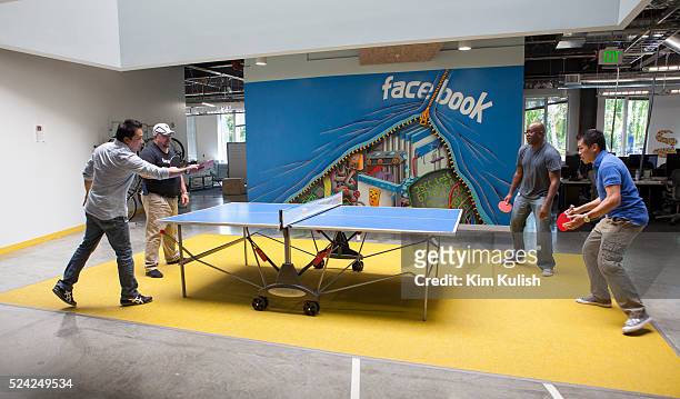 Scenes of daily work and life at Facebook , Inc. USA Headquarters in Menlo Park, California. Facebook employees relax with a game of ping-pong on...