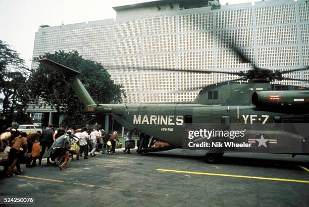 Civilian evacuees board US Marine helicopter inside US Embassy compound to be helilifted to the US Seventh Fleet ahead of Communist troops about to...