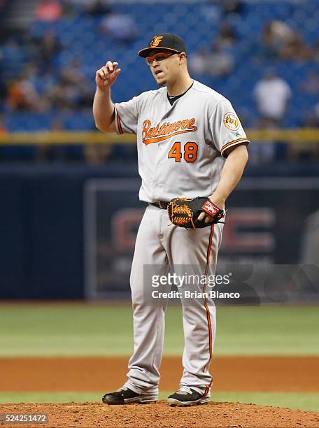Pitcher Vance Worley of the Baltimore Orioles reacts on the mound after hitting Curt Casali of the Tampa Bay Rays with a pitch with the bases loaded...