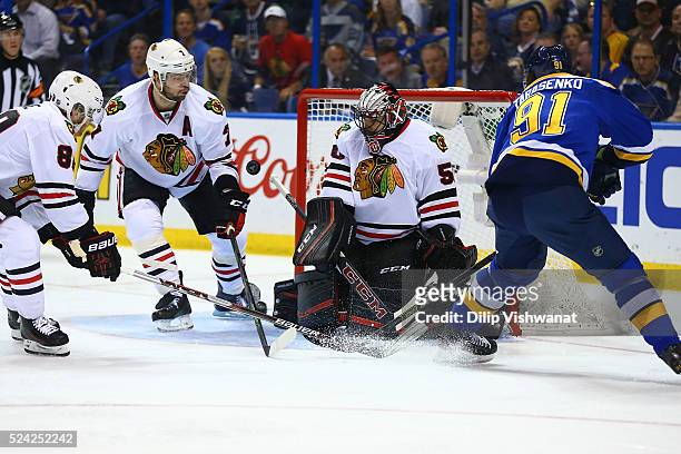 Brent Seabrook and Corey Crawford of the Chicago Blackhawks defend the goal against Vladimir Tarasenko of the St. Louis Blues in Game Seven of the...