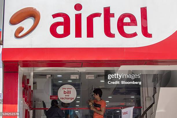 Customers wait to pay their bills at a Bharti Airtel Ltd. Store in New Delhi, India, on Sunday, April 24, 2016. Bharti, India's largest mobile-phone...