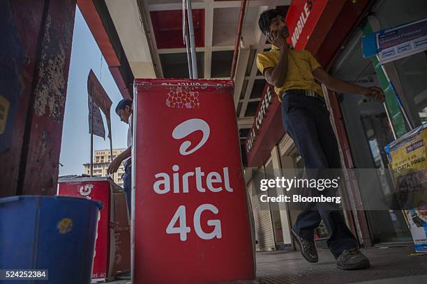 Signage for Bharti Airtel Ltd. Is displayed outside a store in New Delhi, India, on Sunday, April 24, 2016. Bharti, India's largest mobile-phone...