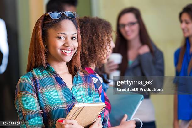 stylish african american teen walking to class in high school - college preparation stock pictures, royalty-free photos & images