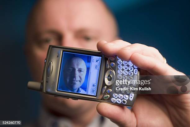 The image of Sean Maloney, Executive Vice President and General Manager, Intel Communications Group is seen on his Treo cell phone with keyboard and...