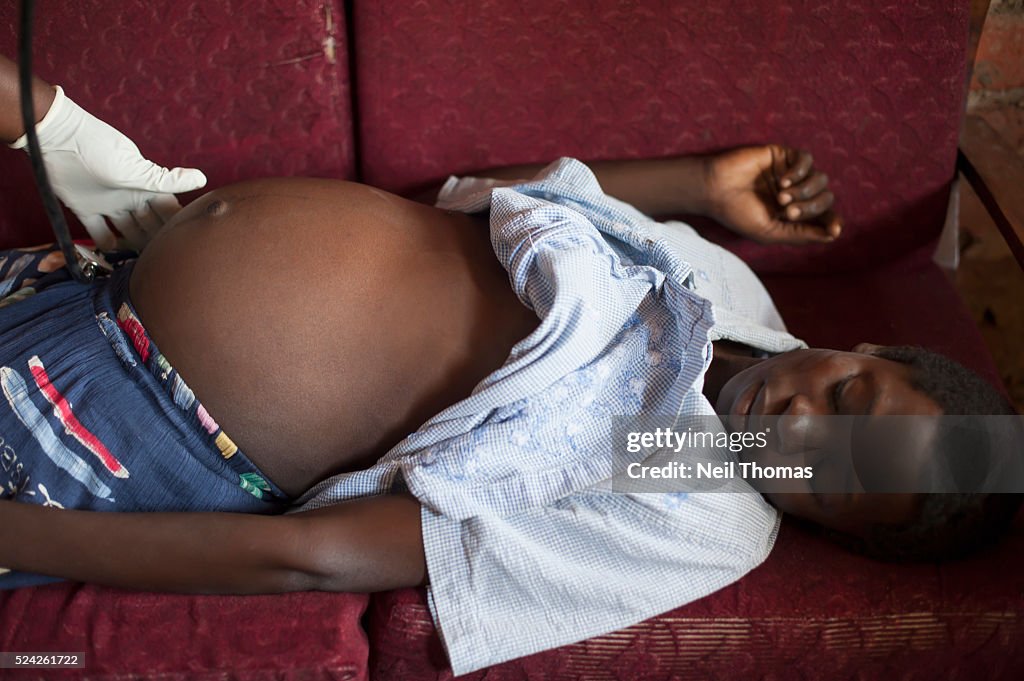 Pregnant African Woman is Examined by a Nurse