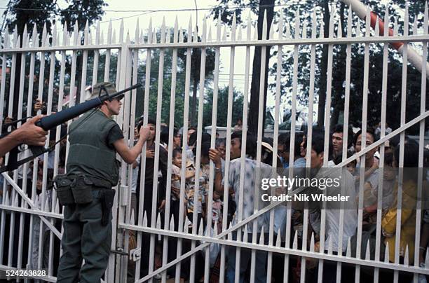 Desperate and frightened South Vietnamese try to convince US Marines guarding the American Embassy to let them into the compound hoping that they...