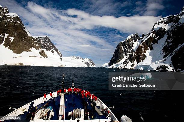 Tourists enjoy the scenery from the deck of the ice-breaker Le Diamant in Lemaire Channel, owned by the Compagnie des Iles du Ponant that can...