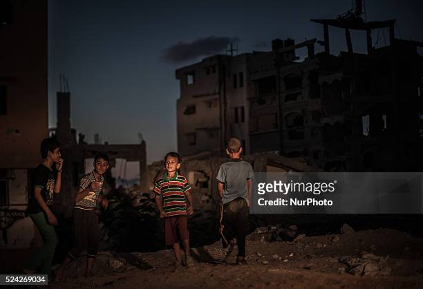 Palestinian children play next to buildings destroyed during the 50-day conflict between Hamas militants and Israel, in Shejaiya neighbourhood in the...