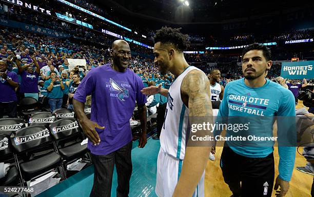 Charlotte Hornets owner Michael Jordan congratulates guard Courtney Lee after the team defeated the Miami Heat on Monday, April 25 at Time Warner...