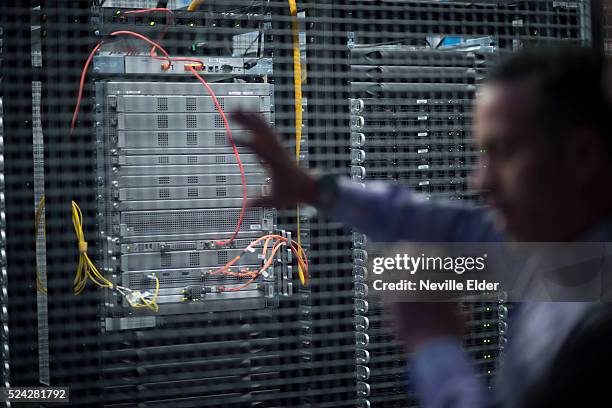 Elios Astudillo, sales Engineer points out a server inside Index Exchange's cage at Equinix 's Data transfer center in New Jersey. High speed data...