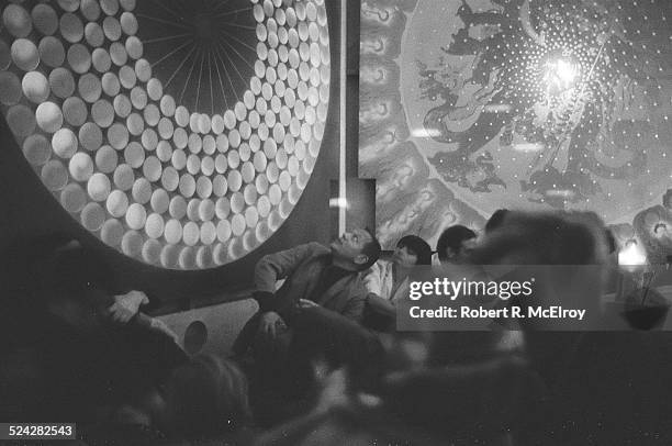 Filmmaker Agnes Varda, center right, among a group of staff, members, and attendees of the New York Film Festival, looks up at imagery on the wall,...